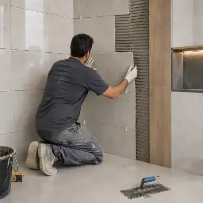 Bathroom wall tiles being set by an ArabCare tiler