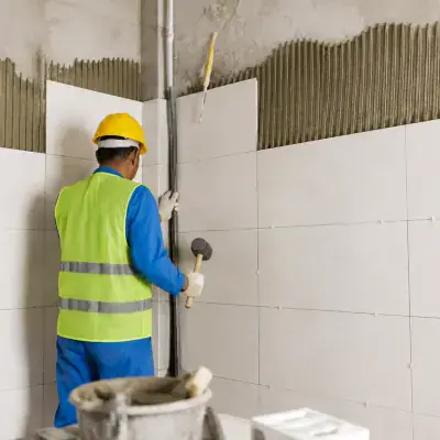 ArabCare tiler fixing large format wall tiles in Dubai