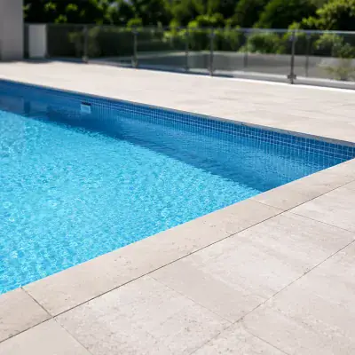 Non-slip stone pool deck beside a villa swimming pool