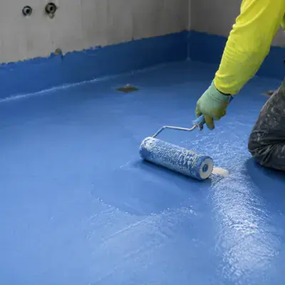 Waterproof membrane rolled onto a bathroom floor before tiling